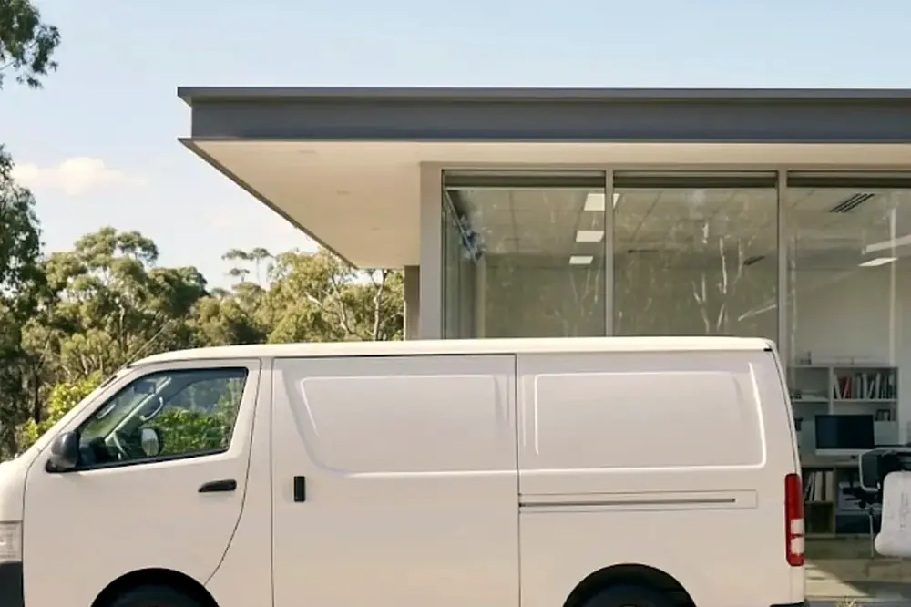 White service van parked outside a modern Sunshine Coast office building