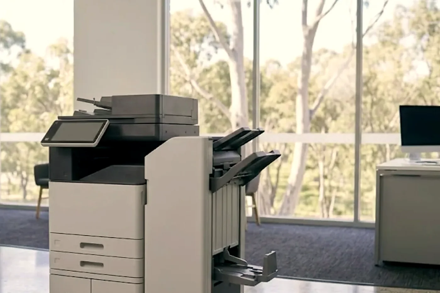 Floor standing copier with finisher in a bright open plan Sunshine Coast office